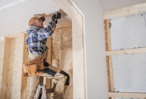 general building contractor attaching drywall