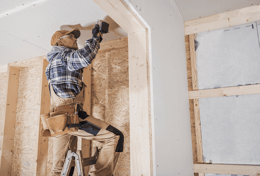 general building contractor attaching drywall